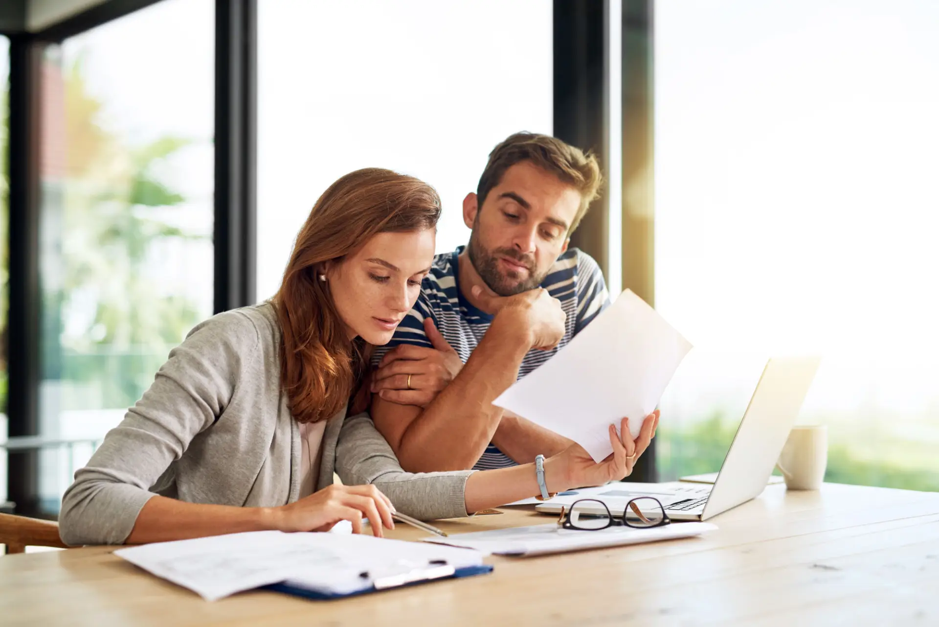 Couple reviewing mortgage term options together at a table with a laptop