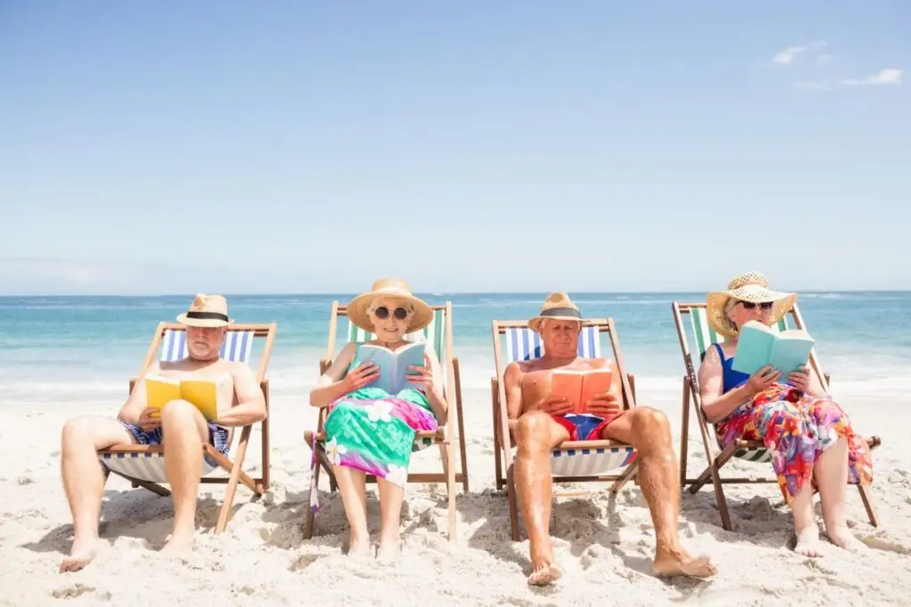 Retired friends relaxing in beach chairs by the ocean